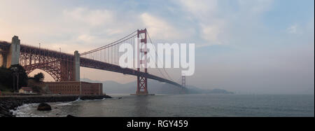 Beautiful panoramic view of Golden Gate Bridge during a cloudy sunset. Taken in San Francisco, California, United States. Stock Photo