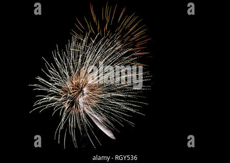 Colorful fireworks of various colors on black background Stock Photo