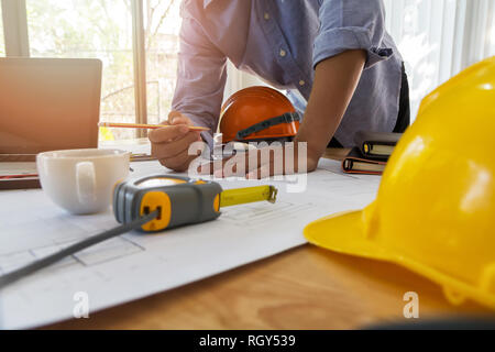 Architect or engineer working on blueprint in office, architectural concept Stock Photo