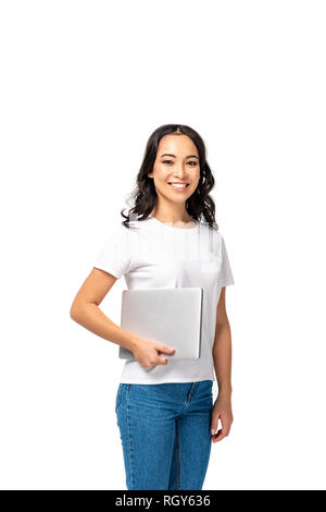Smiling young asian woman in white t-shirt and blue jeans holding laptop isolated on white Stock Photo