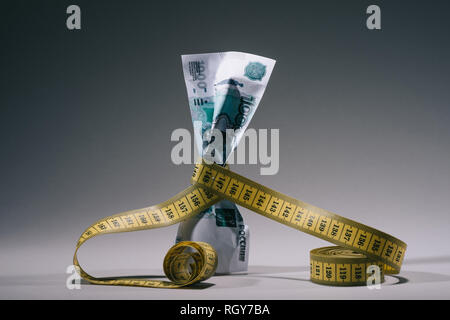close-up view of russian rubles banknote with measuring tape on grey Stock Photo