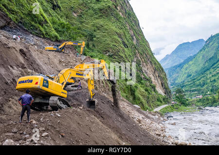 Caterpillars are repairing a road destroyed by a landslide during heavy monsoon rain in Kali Gandaki valley Stock Photo