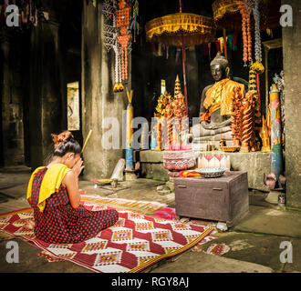 Praying woman in a buddhist - Cambodia Stock Photo