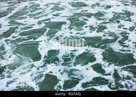 Sea water surface close-up with foam Stock Photo