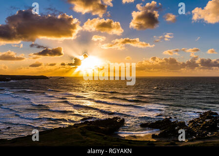 Sunset over stormy waves and surf at Fistral Beach, Newquay, Cornwall, UK Stock Photo
