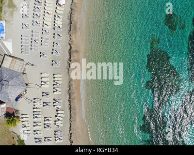 Aerial view of the Caribbean Sea with beach chairs at Reggae Beach near Christopher Harbor, Saint Kitts Stock Photo