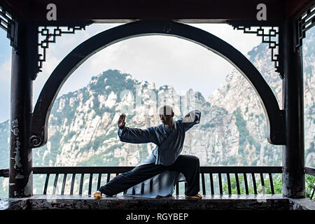 Shaolin monk is training in the mountain temple Stock Photo
