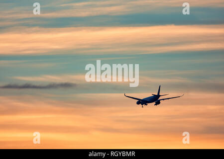 Airplane taking off in the sunset Stock Photo