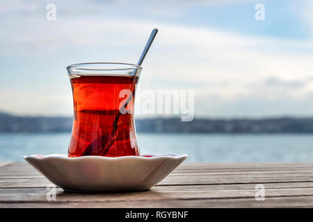 Turkish tea served in the typical manner, in a glass on a small saucer Stock Photo