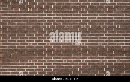 A dark brown brick wall for a textured and patterned background. Stock Photo