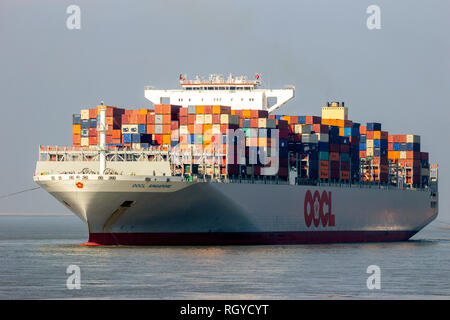 ANTWERP, BELGIUM - MAR 12, 2016: Container ship OOCL Singapore leaving a container terminal in the Port of Antwerp. Stock Photo