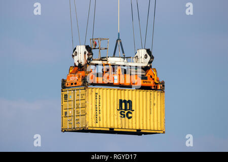 ROTTERDAM - MAR 16, 2016: Crane operator unloading a sea container from a cargo ship the Port of Rotterdam. Stock Photo