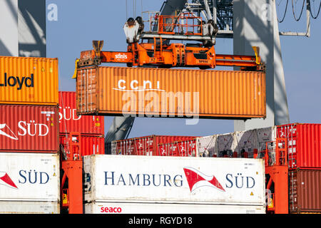 ROTTERDAM - MAR 16, 2016: Crane operator unloading a sea container from a cargo ship the Port of Rotterdam. Stock Photo