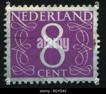 RUSSIA KALININGRAD, 21 JUNE 2017: stamp printed by Netherlands shows emblem, figure, number and symbol, circa 1946 Stock Photo