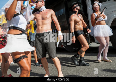 RIO DE JANEIRO - JANUARY  30, 2016: Young Brazilians celebrate Carnival in skimpy costumes at an afternoon street party in Ipanema. Stock Photo