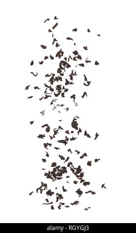 Falling dried tea leaves isolated on white background. Stock Photo