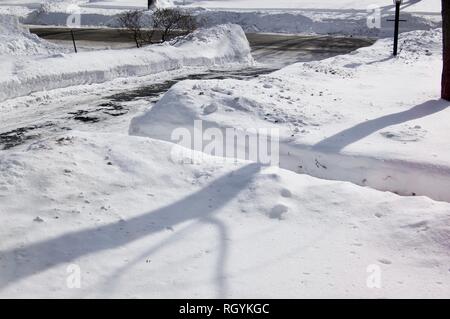 Snow Covered Yard with Shoveled Path and Driveway after a Snowstorm Stock Photo