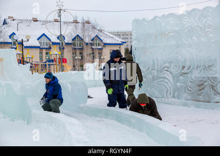 Electricians mount a power cable to illuminate ice figures. Stock Photo