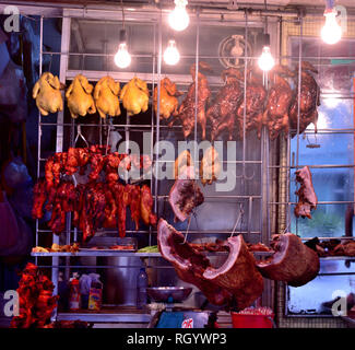 Rack of Cantonese style barbecued meat displayed at shop front, Hong Kong Stock Photo