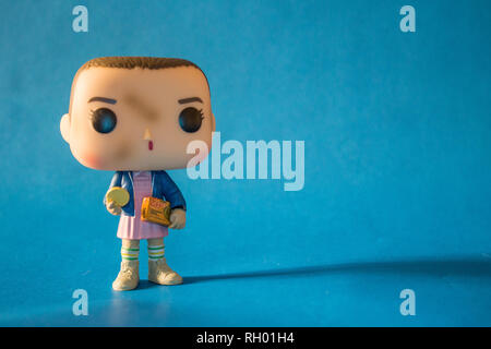 Illustrative editorial of Funko Pop action figure of Eleven with eggos waffles, fictional character from the Netflix series Stranger Things. Stock Photo