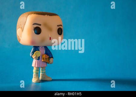 Illustrative editorial of Funko Pop action figure of Eleven with eggos waffles, fictional character from the Netflix series Stranger Things. Stock Photo