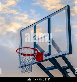 Basketball basket on transparent board against sky Stock Photo