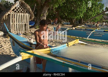 Fisherman and his nets, Saud Beach, Pagudpud, Luzon, Philippines Stock Photo