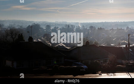 Kent, UK. 31st Jan, 2019. The early morning sun shines through a blue crisp sky illuminating the rooftops, the January cold snap hits the south east of England, looking out across the valley in Kent, steam and vapour plumes from chimneys and roofs, the icy tiled roof tops glisten in the low sunshine. 2018 --- Image by Credit: Paul Cunningham/Alamy Live News Stock Photo