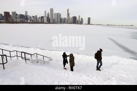 Chicago, USA. 31st Jan, 2019. People walk alongside frozen Lake Michigan in Chicago, the United States, Jan. 31, 2019. Chicago, the biggest city in the U.S. Midwest, was struck by the polar vortex with the minimum temperature reaching minus 30 degrees Celsius in the city. Credit: Wang Ping/Xinhua/Alamy Live News Stock Photo