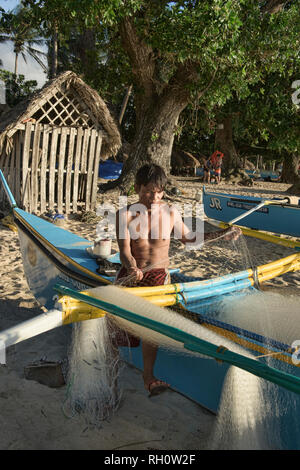 Fisherman and his nets, Saud Beach, Pagudpud, Luzon, Philippines Stock Photo