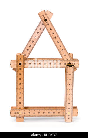 Wooden folding meter ruler in the shape of two house. Isolated on white background. Clipping path included. Stock Photo