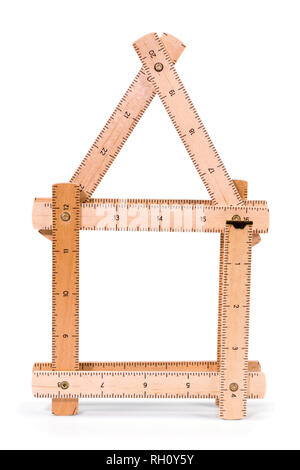 Wooden folding inch ruler in the shape of two house. Isolated on white background. Clipping path included. Stock Photo