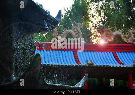 Chinese dragons, statues of ronin and fountains at sunset Russia Stock Photo