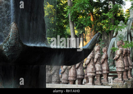 Chinese dragons, statues of ronin and fountains at sunset Russia Stock Photo