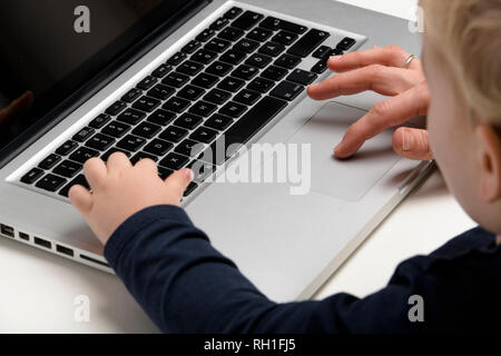 mother and son working on computer Stock Photo