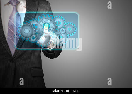 Businessman touch cloud shape filled with gears icon in space for launching service in gray background Stock Photo