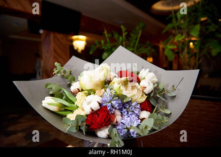 A stylish bouquet of flowers in the restaurant hall. Stock Photo