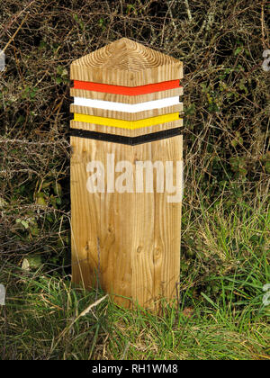 Colour Coded Wooden Post, with red, white, yellow, and black bands, on the South West Coast Path, UK Stock Photo