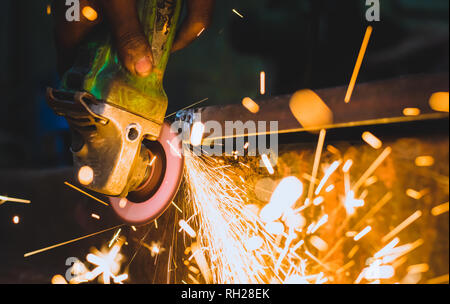 Worker using a grinder on a metal Stock Photo