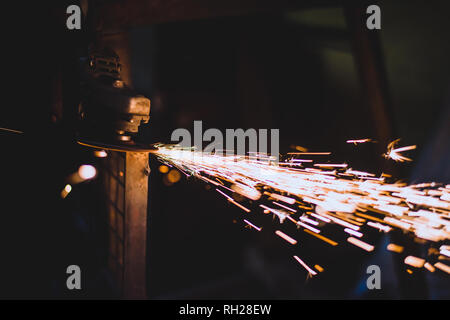 Worker using a grinder on a metal Stock Photo