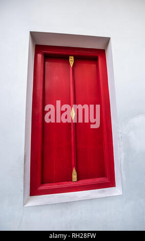 Single Red Door with gold decorative elements Stock Photo