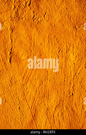 closeup of a rustic orange plastered wall to be used as a background Stock Photo