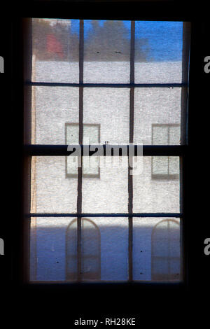 windows and house frontage seen through window blind Stock Photo