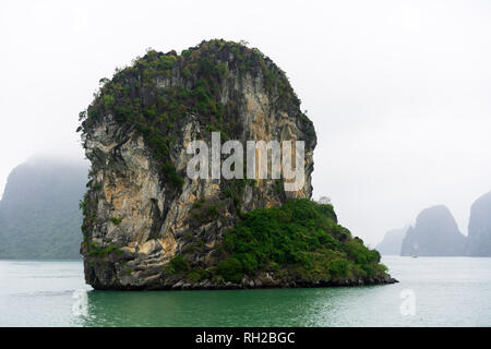 Halong Bay in mystical clouds. Mystical atmoshpere in the world famous halong bay. Stock Photo