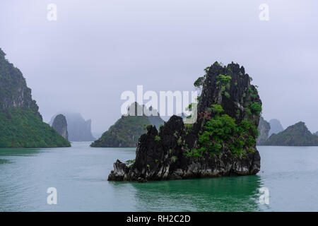 Halong Bay in mystical clouds. Mystical atmoshpere in the world famous halong bay. Stock Photo