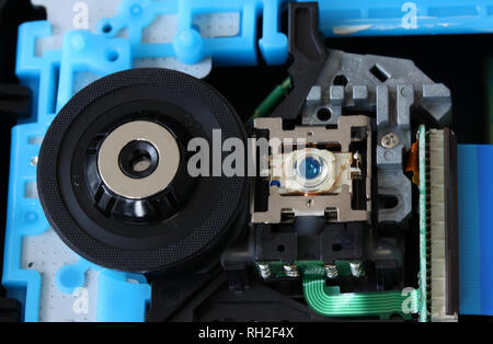 CD inside a DVD payer showing optical pick up laser lens with circuits, cables and boards - close up Stock Photo