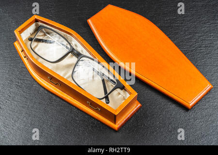 Glasses in coffin.Laser eye surgery or Buy Your Contact Lenses concept Stock Photo