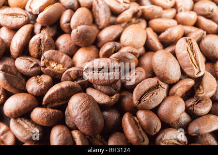 Coffee scattered on the table. Coffee beans dark background espresso. Background from spilled coffee beans. Stock Photo