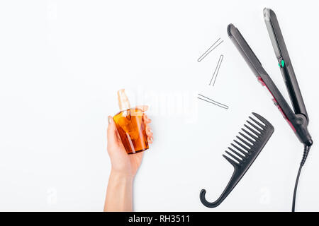 Hair straightener and bottle of nutritional oil on white table, view from  above. Concept hair styling and thermal protection, flat lay Stock Photo -  Alamy