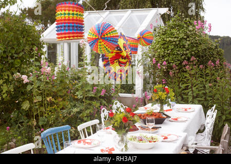 Table in garden ready for party Stock Photo